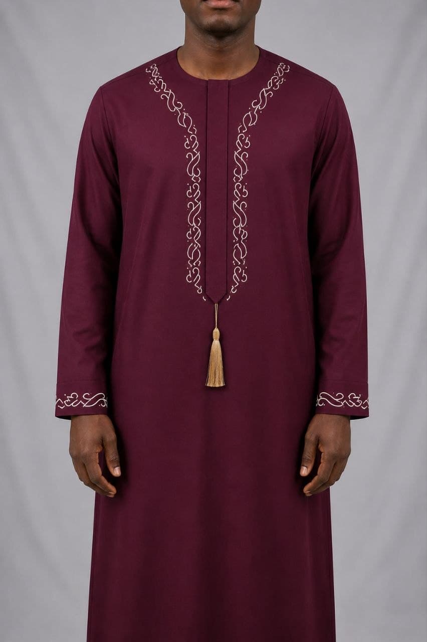 Maroon jallabiya with cream scrollwork and a gold cord tassel